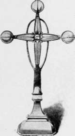 Altar Cross of polished brass, with enamels introduced at the extremities.