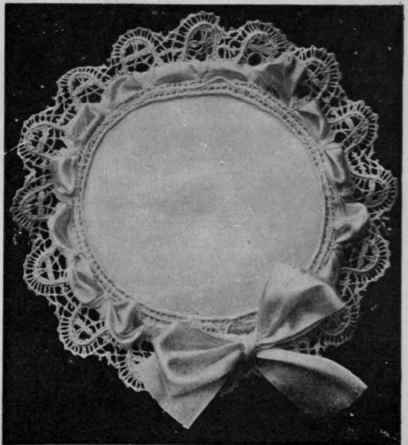 A lace edged d'oyley makes a charming cushion cover