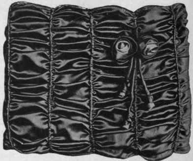 A large muff made of piped silk with silk roses