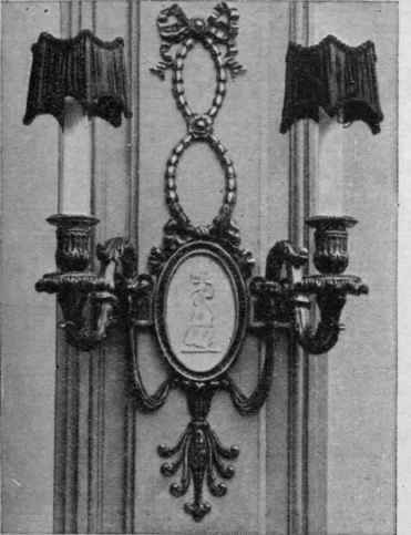 An effective wallbracket, with porcelain candles, that can be fitted for electric or incandescent gas light