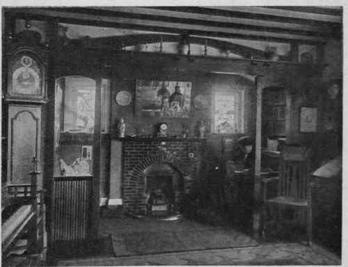 An ingle nook is a delightful addition to a hall which is occasionally used as a sitting room. This photograph shows a fireplace in various tones of rich deep green