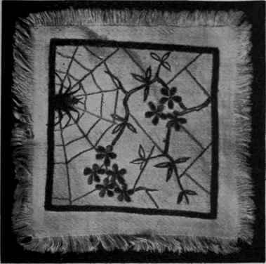 The Japanese feeling is emphasised by the prunus spray. Dark grey embroidery silk forms the frame, pale grey the spider's web, brown the stems, and pale pink the peach blossoms