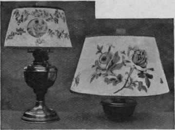 Two pretty lampshades. The one on the left is decorated with a picture let in from the back