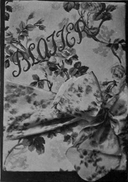 A blotting case of rose printed chintz, with fastening of rose and white Chine ribbon