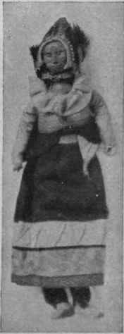 Doll from Peru in cloth clothes with bead ornaments