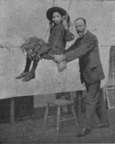 Mr. Vicat cole posing a child model for the skertching class