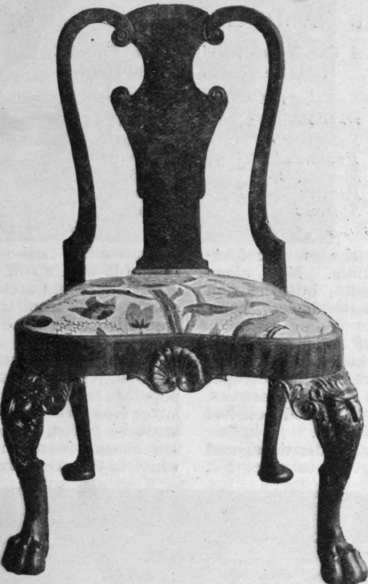 A chair of the Queen Anne period, with its seat covered with hand embroidery. Such a chair affords a most interesting opportunity for the clever needlewoman