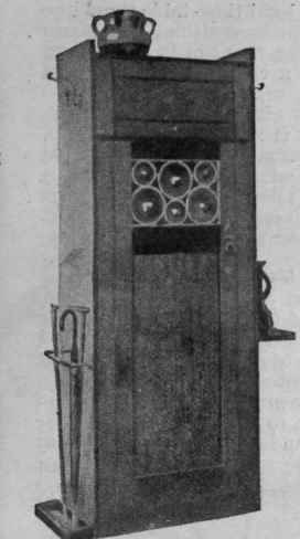 A useful oak stand for a small hall. It takes little floor space and is of good design