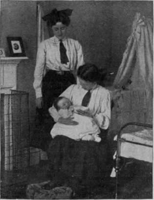 Feeding a baby in the nursery at Highcliff School. The girls learn the proper preparation of infants' food as well as other details of nursery routine
