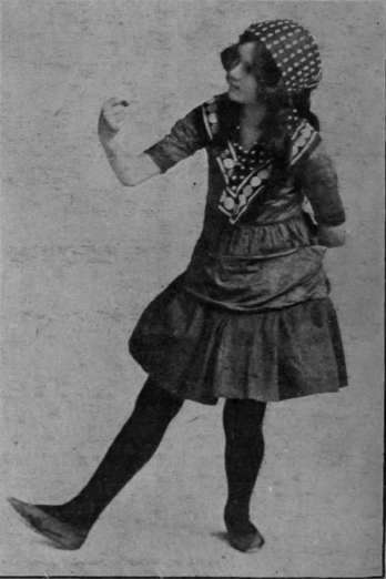 Fig. 7. Shaking fist. At this step the dancer advances with heel extended and her fist raised. The feet are then closed together, and the step repeated to the left side
