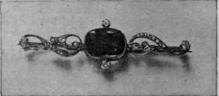 The peridot is the stone for September. It can be set in gold, but needs diamonds to display its beauties, as exemplified in the brooch here shown