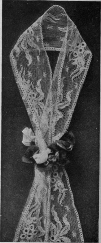 A tiny wreath of roses makes a delightful slide for a lace scarf or ribbon necktie
