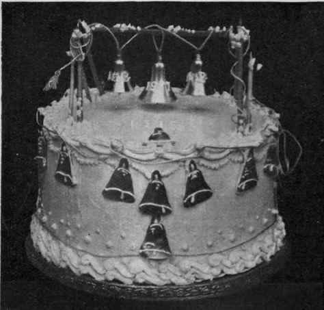 An arrangement of tiny silver bells is very appropriate for the decoration of a silver wedding cake. Initials and dates can be piped in icing sugar on the upper bells