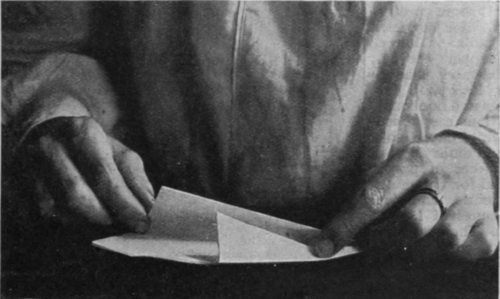 Folding a quarter of the paper on either side towards the centre