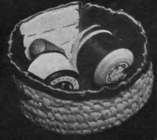 Raffia work basket lined with silk and fitted to hold cotton and needles, etc