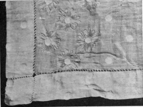 Round each spot in the muslin long stitches are placed in white silk, the spot worked over in yellow silk representing the centre of the flower