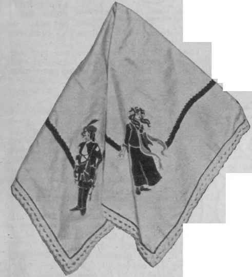 Tablecloth with Peter and Wendy standing sentinel at the corners. A rope of green [satin ribbon joins them, and green stitchery and lace ornament the edge