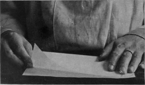 The first step in making paper lace   folding the paper exactly in half