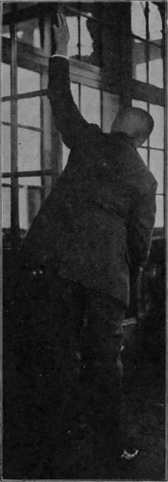 Fig. 100.   First position when utilising a door to re educate arm movements. The patient crawls up with his fingers as high as he can. Note that the door is fixed by the patient's foot