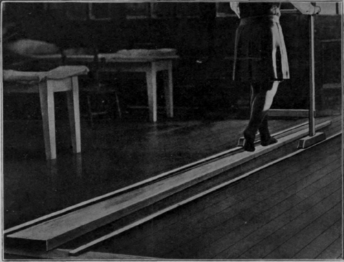 Fig. 117.   Practising rocking on the walking board. The latter is a mere adaptation of a boom, and the trolley replaces a balancing pole