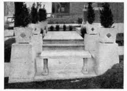 A bench, some flower vases, and a well curb and platform. These well illustrate the range of use of concrete for such objects.