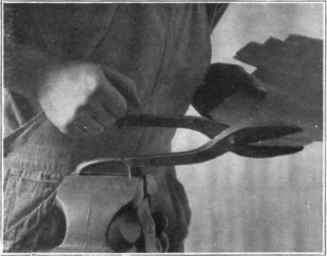 Fig. 105. Cutting copper with snips.