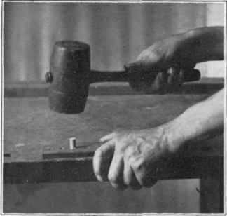 Fig. 132. Driving dowel thru dowel plate.