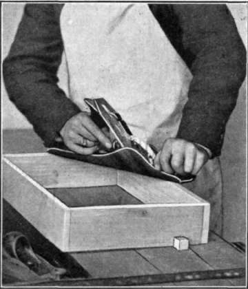 Fig. 160.   Planing the Edge of a Box to Fit the Bottom.