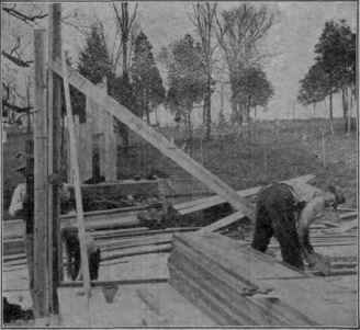 Fig. 33. Corner Post Being Plumbed and Stayed