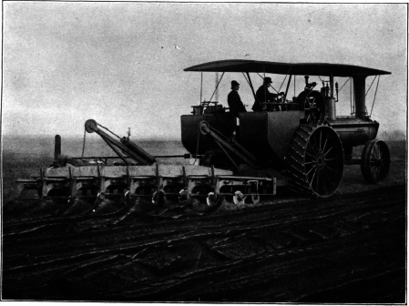 A modern gang plow drawn by a traction engine and turning eight
furrows at a time