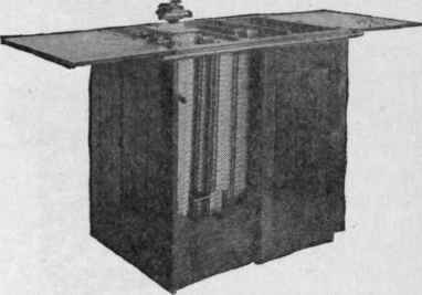 Rubber Chain Addressograph Operated by Foot Lever and Mounted in Wood Cabinet