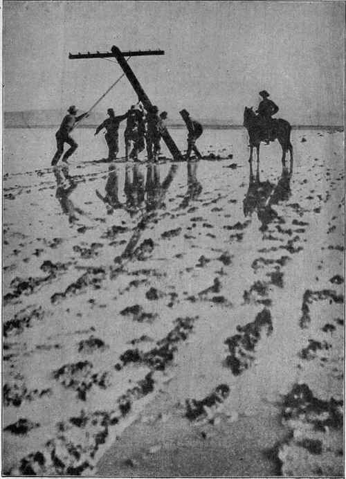 Setting Poles Across a Shallow Lake in Nevada During the Construction of