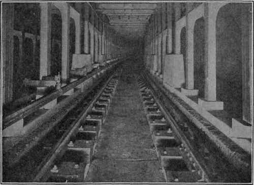Subway Construction In the upper view the electric chart on the wall facing the switch operator indicates the location of every train in the New York subway system at all times. The lower view shows typical subway construction for third rail train and surface cars. The material used is reinforced concrete.