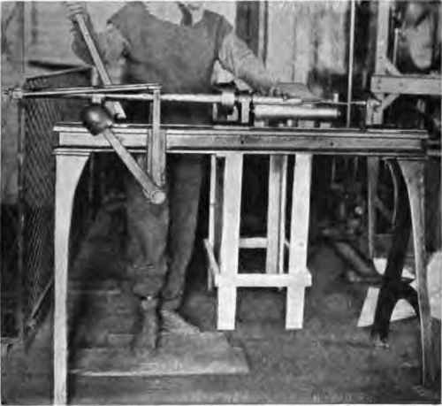 Case rolling machine; feeding paper in slot.