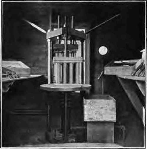 Hydraulic press showing cases in place.