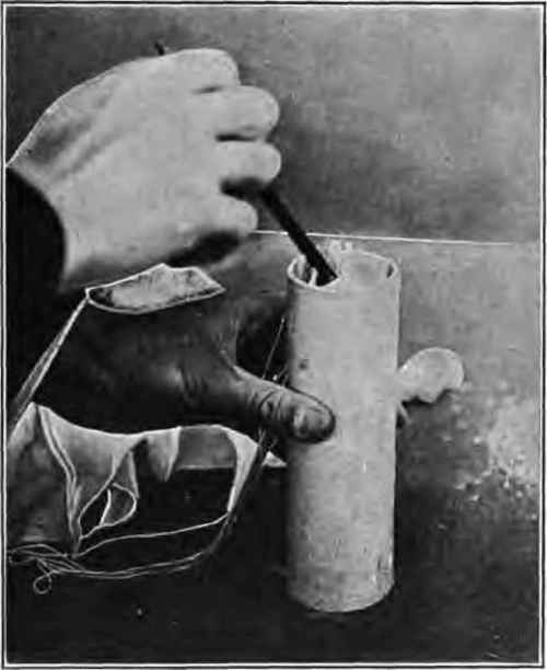 Placing cotton twitting and sawdust around light in rocket head.